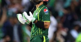 Md Rizwan expressing emotion during a cricket match, wearing a green Pakistan jersey and holding his bat.