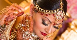 Elegant bridal portrait featuring intricate henna designs, stunning jewelry, and a traditional red wedding outfit.