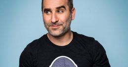 Man wearing a black Todd Squad t-shirt with cartoon graphic, posing against a light blue background. Fun and playful style.