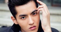 Yifan Wu striking a pose with sleek hairstyle and stylish outfit, showcasing modern fashion and charisma.