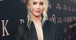 Jennifer Lawrence stunning in a black gown at the "Dark Phoenix" premiere, showcasing her elegant style and radiant beauty.