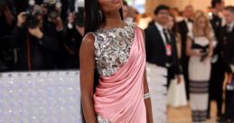 Mayonna Campbell dazzles in a pink gown with silver embellishments at a glamorous red carpet event.