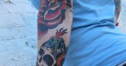 Colorful tattoo of a skull and roses on a person's arm, showcasing vibrant ink artistry and style.