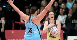 Megan Craig plays in a netball match, defending intensely against her opponent during a dynamic competition.