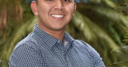 Johan Barbosa smiling confidently, arms crossed, with a lush green background reflecting a serene outdoor setting.