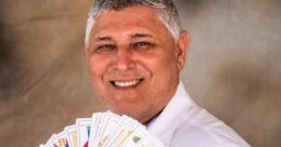 Joao Rosa smiling while holding a fan of tarot cards, showcasing his expertise in tarot reading and divination.