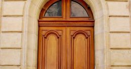 Elegant wooden double doors with intricate carvings and a classic arch, showcasing timeless architectural design.