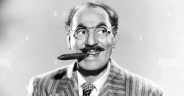 Groucho Marx with a cigar, wearing a striped suit, displaying his iconic playful expression and humor.