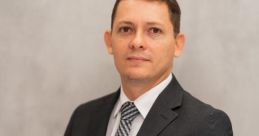 Professional portrait of Laurentino Adriel in a suit, exuding confidence and sophistication against a neutral background.