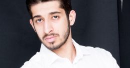 Portrait of a young man in a white shirt, showcasing confidence with crossed arms against a dark backdrop, Erfan Razmi style.