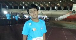 Kavyansh Bedi at a night marathon event, wearing a bib number 149-F, ready to run on the track.