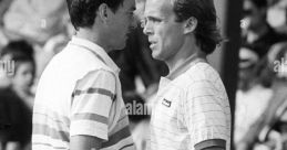 Intense moment between two tennis players during a match, showcasing the competitive spirit and tension of the game.