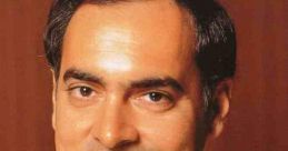 Close-up portrait of Rajiv Gandhi, former Prime Minister of India, smiling with hands clasped, wearing a traditional outfit.