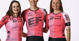 Cycling team members in pink and black jerseys representing E F pose together, showcasing team spirit and athleticism.