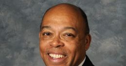 Professional portrait of Reginald Mamaril in a suit and tie, smiling against a textured background.