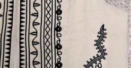 Embroidered vest featuring intricate black designs on cream fabric, showcasing traditional craftsmanship and style.