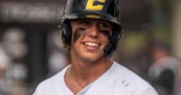 Bryan Arendt smiles during a baseball game, showcasing skills in his Canes uniform, number 15, with a confident stance.