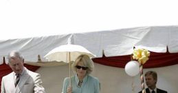 Camilla O'Donnell Morrison observes a children's activity with Prince Charles at a festive outdoor event.