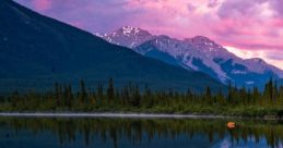 Scenic mountain lake reflecting a pink sky, featuring the biblical verse John 21:18 KJV for inspiration and reflection.