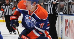 Edmonton Oilers player #4 skating on the ice during an NHL game, showcasing agility and skills in professional hockey action.