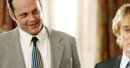 Two men in suits enjoy drinks and engage in humorous conversation at a wedding, highlighting a fun wedding crashers vibe.