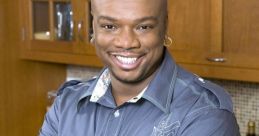 Host of "Big Daddy's House" smiling in a modern kitchen, showcasing cooking skills and charisma for food enthusiasts.