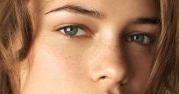 Close-up portrait of a girl with natural beauty, soft features, and tousled hair, emphasizing her clear skin and expressive eyes.