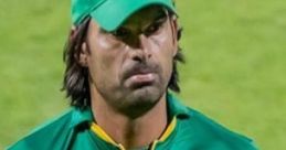 Muhammad Irfan Asmawi in Pakistan cricket jersey, showcasing team spirit during a match with a focused expression.