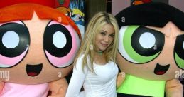 E. G. Daily poses with Buttercup and Blossom from The Powerpuff Girls at a promotional event, showcasing her voice acting role.