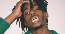 Playboi Carti showcases his unique style, featuring a green jacket and flashy grill, with a confident expression.