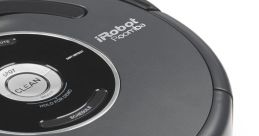 iRobot Roomba vacuum cleaner featuring control buttons for cleaning and scheduling in a sleek, compact design.