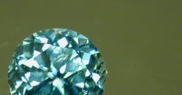 Brilliant blue Zircon gemstone reflecting light, showcasing its captivating sparkle and unique cut on a reflective surface.