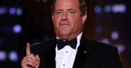 Chris Berman in a tuxedo delivering a speech at an awards ceremony, showcasing his signature charismatic style.