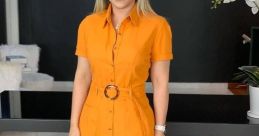 Woman in a stylish orange dress with a belt, showcasing a vibrant and modern fashion look, perfect for GIOVALDO "lindíssima" style.