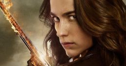 Wynonna Earp wields a flaming gun, showcasing her fierce determination and iconic style in a gritty, supernatural landscape.