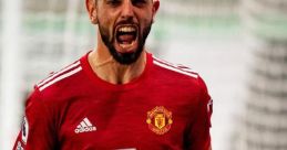 Bruno Fernandes celebrates passionately in his Manchester United jersey, showcasing his fierce determination on the field.