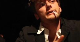 Man with a cigarette gestures thoughtfully at a table, reflecting tension and drama in a cinematic scene inspired by 5secondsfilm.