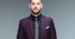 Mike Rome showcases a stylish purple suit, exuding confidence with a sharp look and a poised stance. Perfect for events.