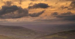 White Tesla Model S parked on a scenic hilltop with a dramatic sunset backdrop, showcasing electric vehicle innovation.