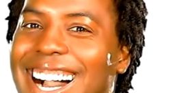 Cheerful man wearing a red shirt and silver jewelry, showcasing a bright smile against a white background. Samwell vibes.