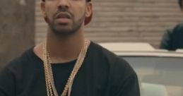 Drake in a black and white striped shirt, gold chains, and a red cap from the "Worst Behavior" music video.