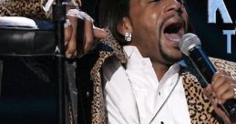 Katt Williams performing passionately in leopard print, showcasing his vibrant style and charisma on stage.