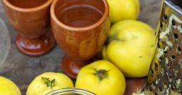 Quince fruits, grated and dried quince shavings in a jar, and clay mugs on a rustic wooden table. Perfect for "Anders kan du torka.