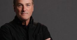 Michael W. Smith poses confidently, wearing a black jacket, showcasing his signature style and approachable charm.