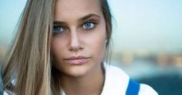 Portrait of a Russian girl with striking blue eyes and long hair, wearing a blue and white outfit, exuding elegance and confidence.