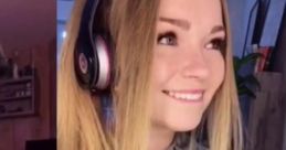 Australian TikTok gamer girl with long hair, headphones, and a game controller, smiling while playing Xbox.