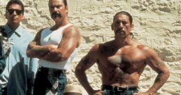 Key characters from "Blood In Blood Out" standing against a textured wall, showcasing camaraderie and street culture.