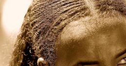 Portrait of an Ethiopian girl with braided hair and traditional jewelry, capturing the beauty of Amhara culture.