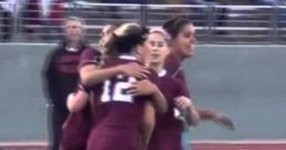 Celebrating teamwork on the field, the Red Oak Lady Hawks unite in joy after a successful play during a soccer match.