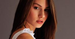 Young woman with long hair posing confidently, showcasing Hungarian style and elegance in a chic white top.